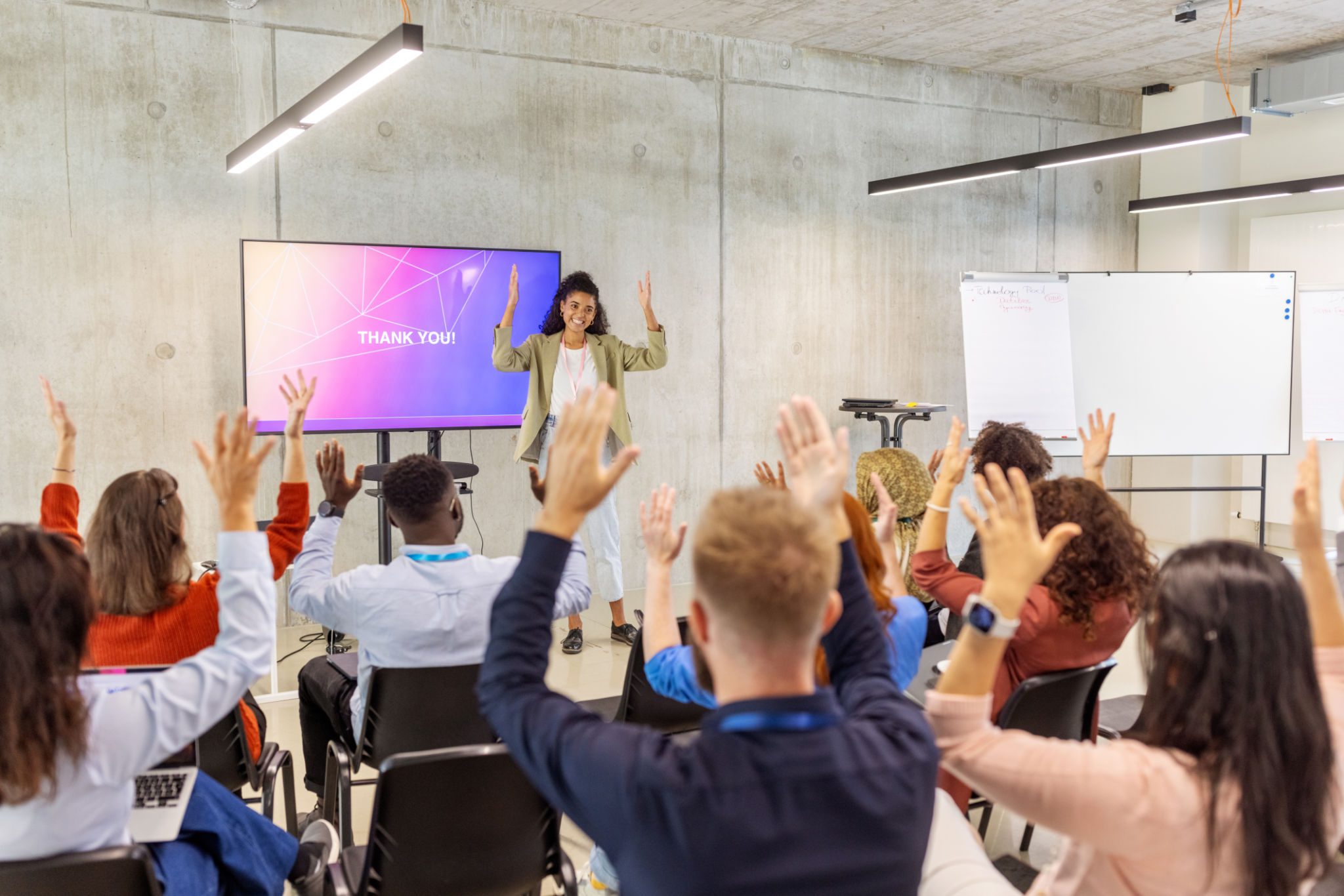 Audience raising hands during a presentation